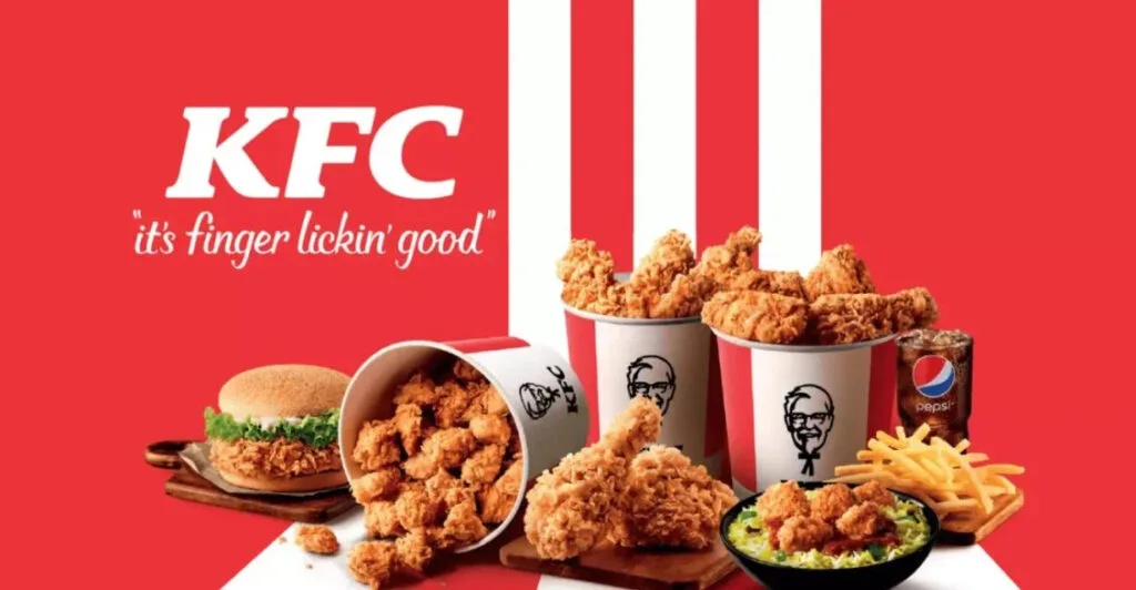 KFC bucket meals with crispy fried chicken, chicken burger, french fries, coleslaw, and Pepsi on a red background with the slogan "it's finger lickin' good"